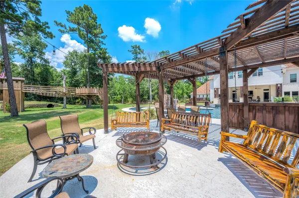 a view of a patio with a table chairs and a backyard