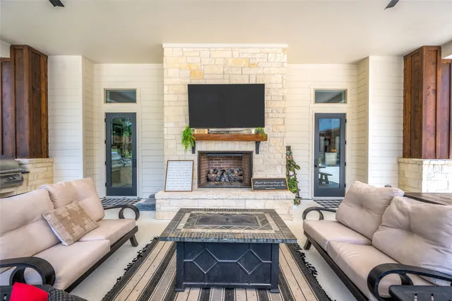 a living room with furniture a flat screen tv and a fireplace