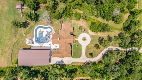an aerial view of a house with garden space and street view