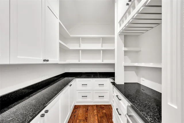 a kitchen with a stove and white cabinets