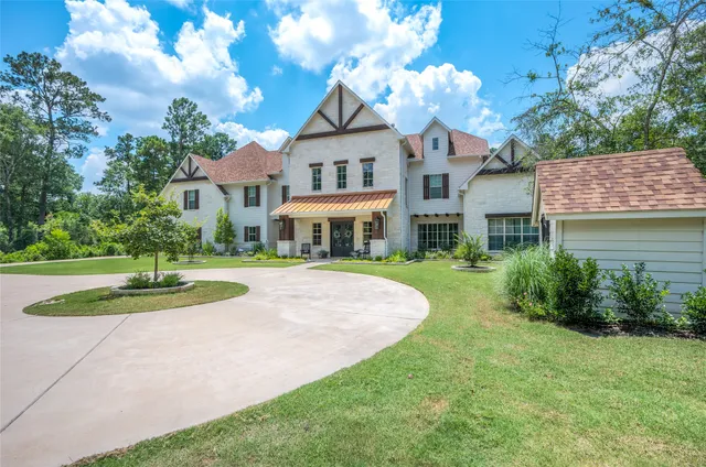 a front view of a house with yard and green space