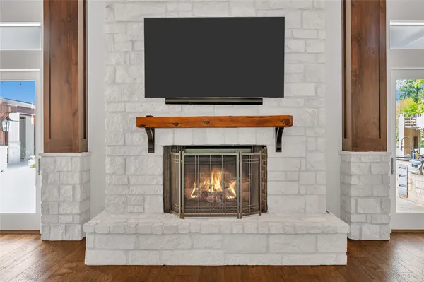 a living room with a fireplace and a flat screen tv