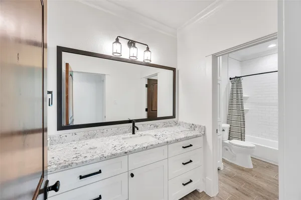a bathroom with a granite countertop sink mirror and