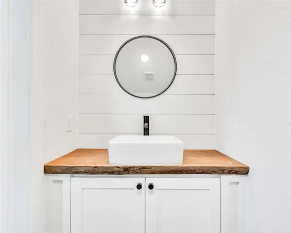 a sink with a mirror and vanity