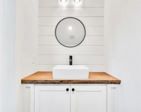 a sink with a mirror and vanity