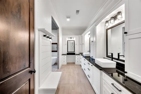 a large bathroom with a double vanity sink a mirror and a shower