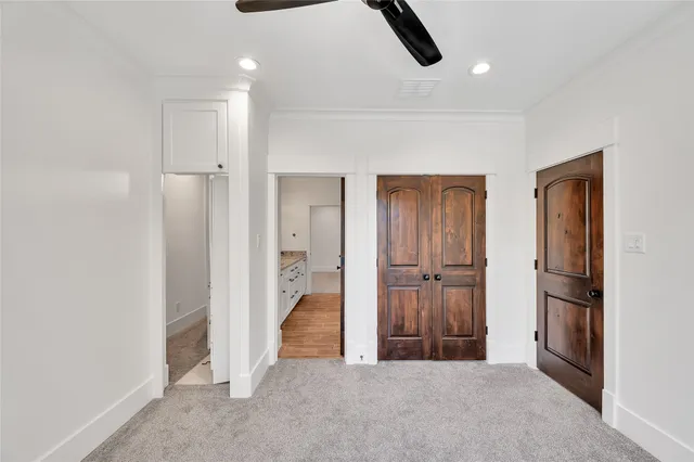 a view of a livingroom with wooden floor and cabinet
