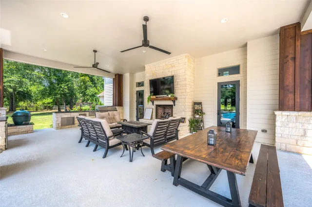 a dining room with furniture floor to ceiling windows and a fireplace