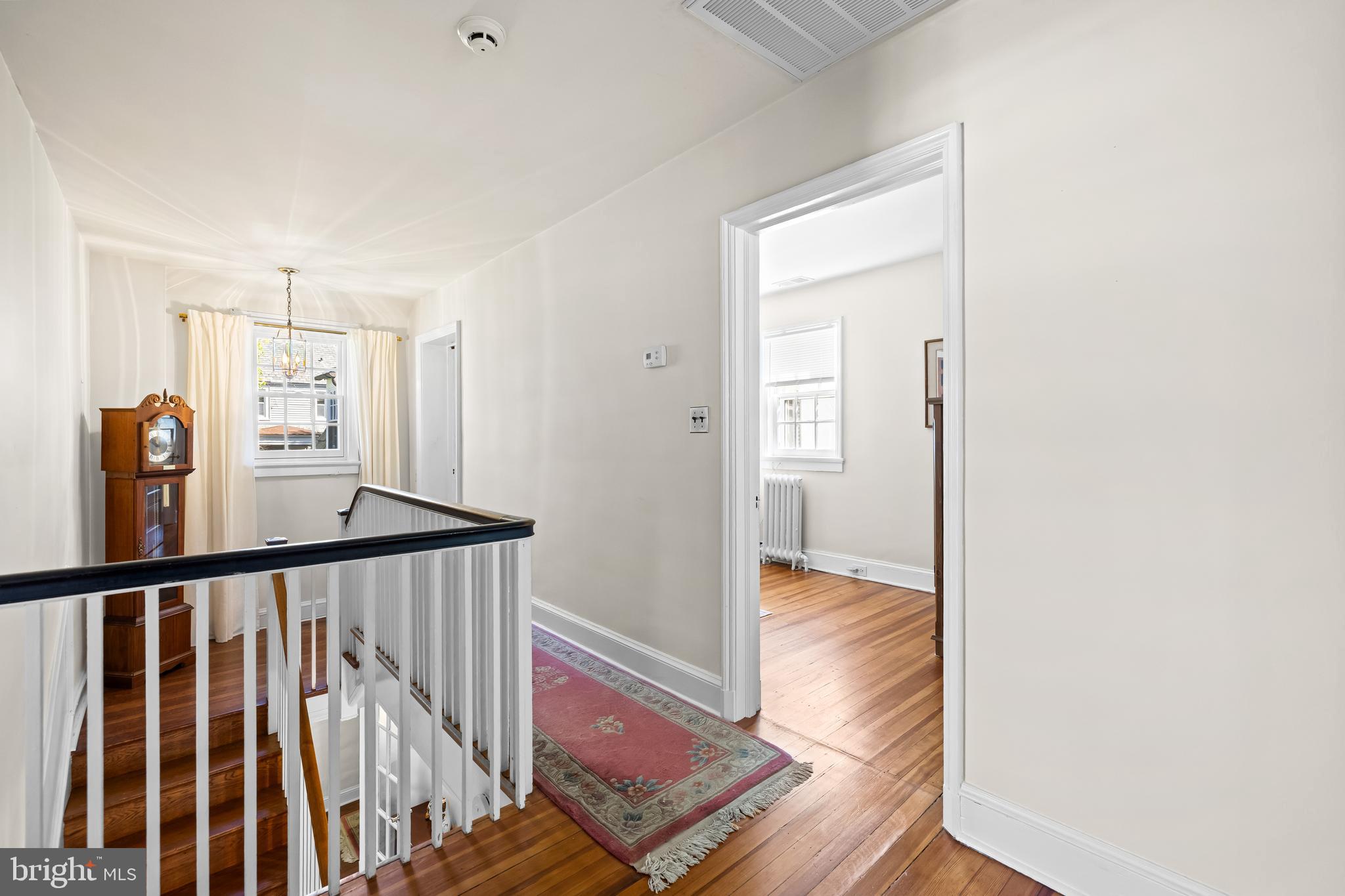 4309 Wendover Road Baltimore, MD 21218 - Photo 35 of 56 a view of a hallway with wooden floor and stairs