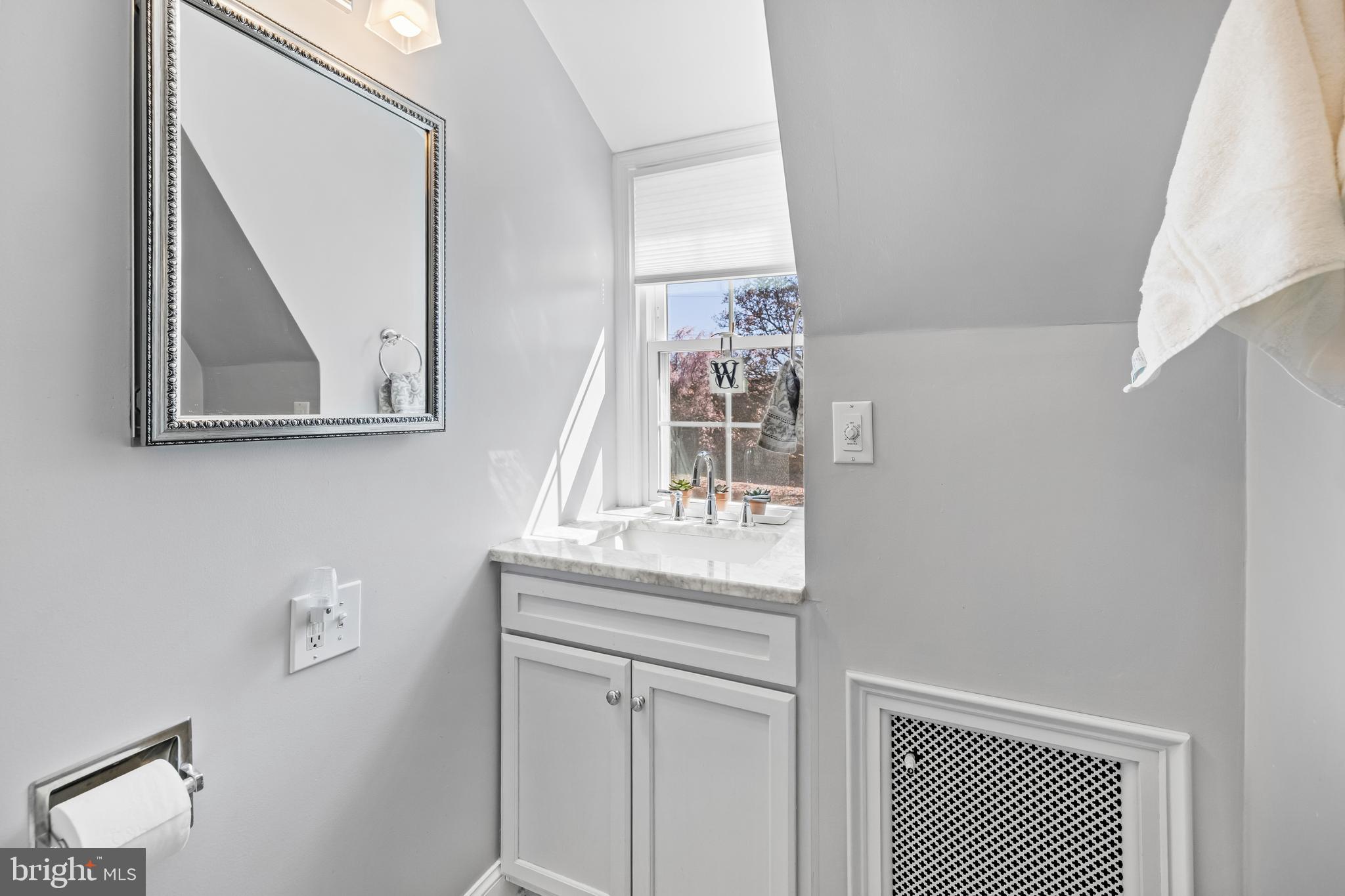4309 Wendover Road Baltimore, MD 21218 - Photo 40 of 56 a bathroom with a sink a mirror and a window