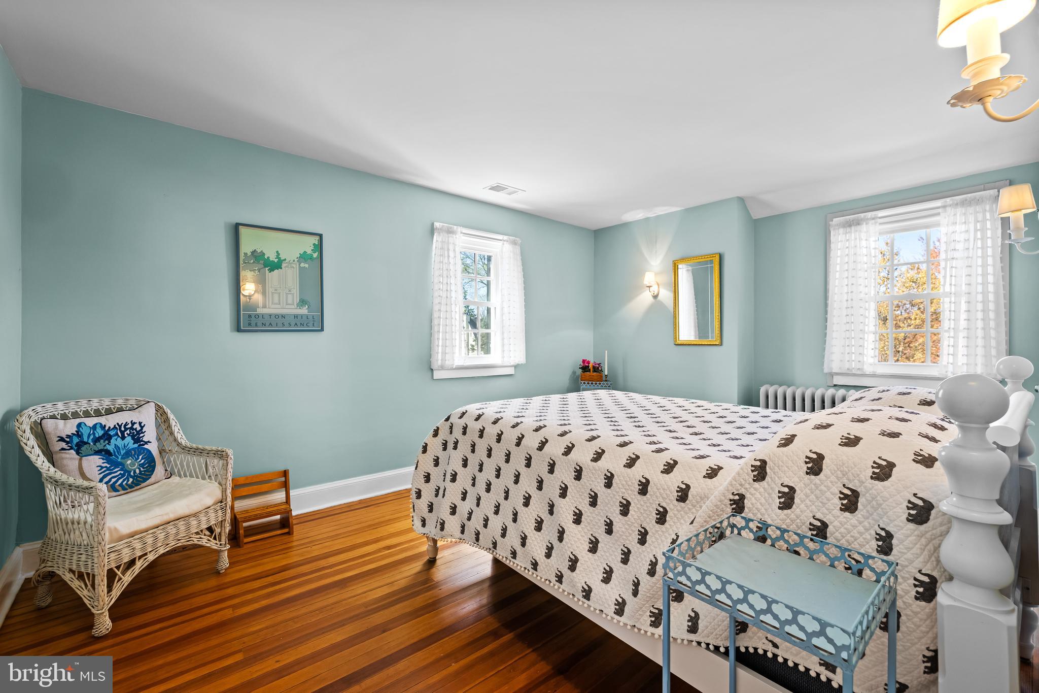 4309 Wendover Road Baltimore, MD 21218 - Photo 41 of 56 a bedroom with a bed and wooden floor