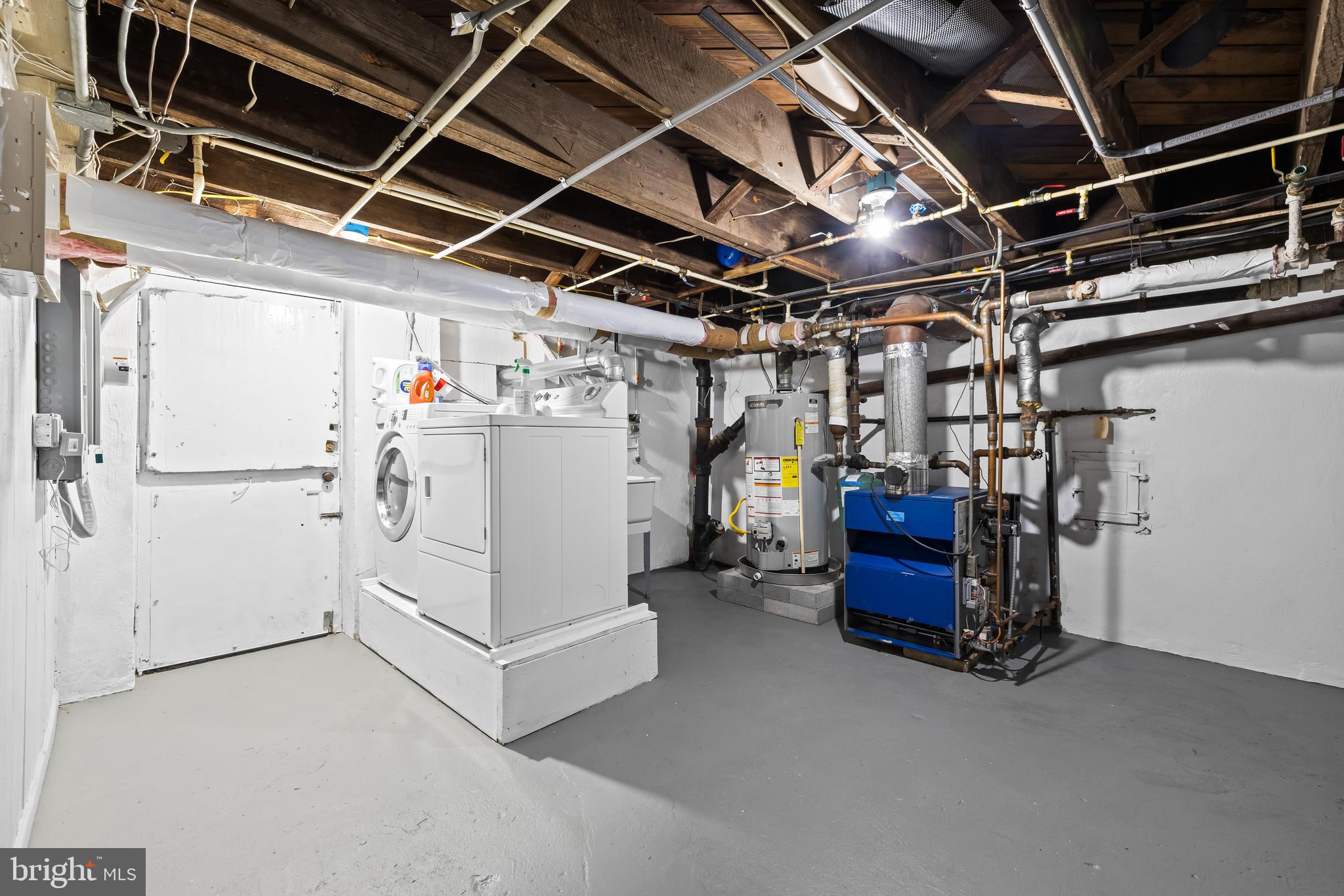 4309 Wendover Road Baltimore, MD 21218 - Photo 46 of 56 a utility room with dryer and white cabinets
