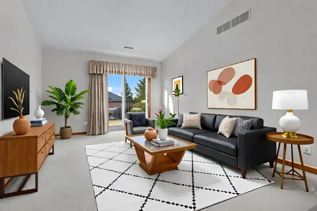 a living room with furniture potted plant and a large window