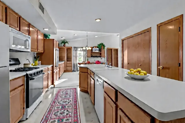 a kitchen with stainless steel appliances lots of counter space and wooden floor
