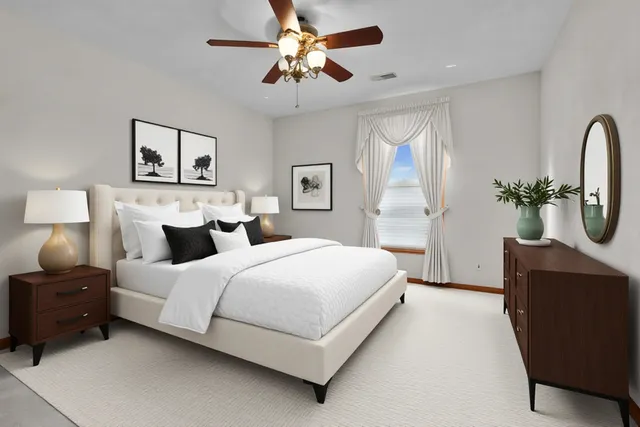 a spacious bedroom with a bed and a chandelier