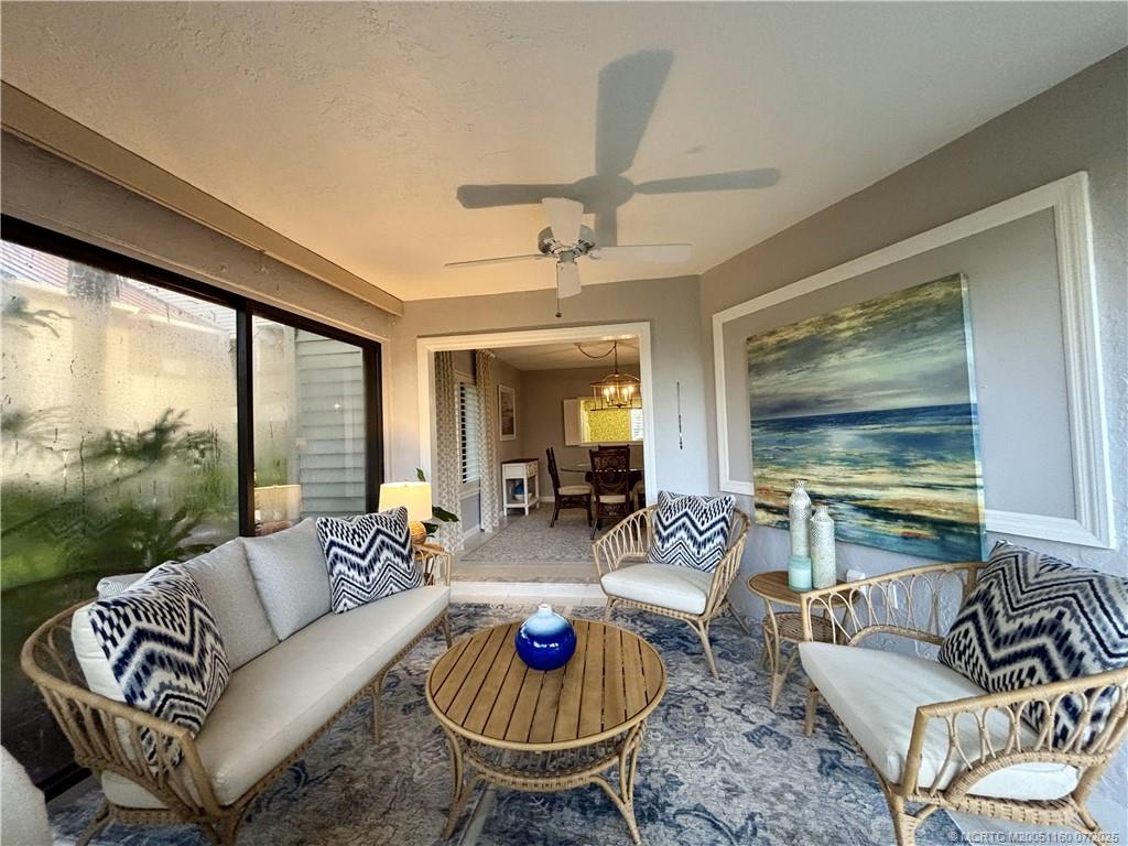 5152 Southeast Club Way, Unit 104 Stuart, FL 34997 - Photo 11 of 28 a living room with furniture and a large window