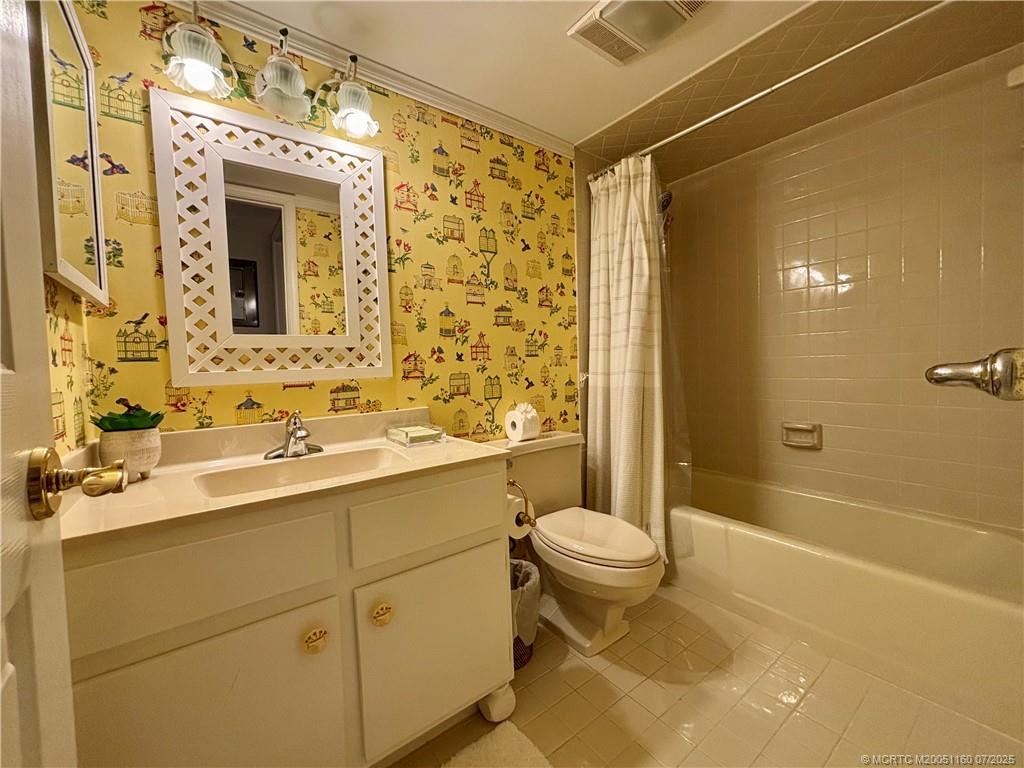 5152 Southeast Club Way, Unit 104 Stuart, FL 34997 - Photo 14 of 28 a bathroom with a sink toilet and shower