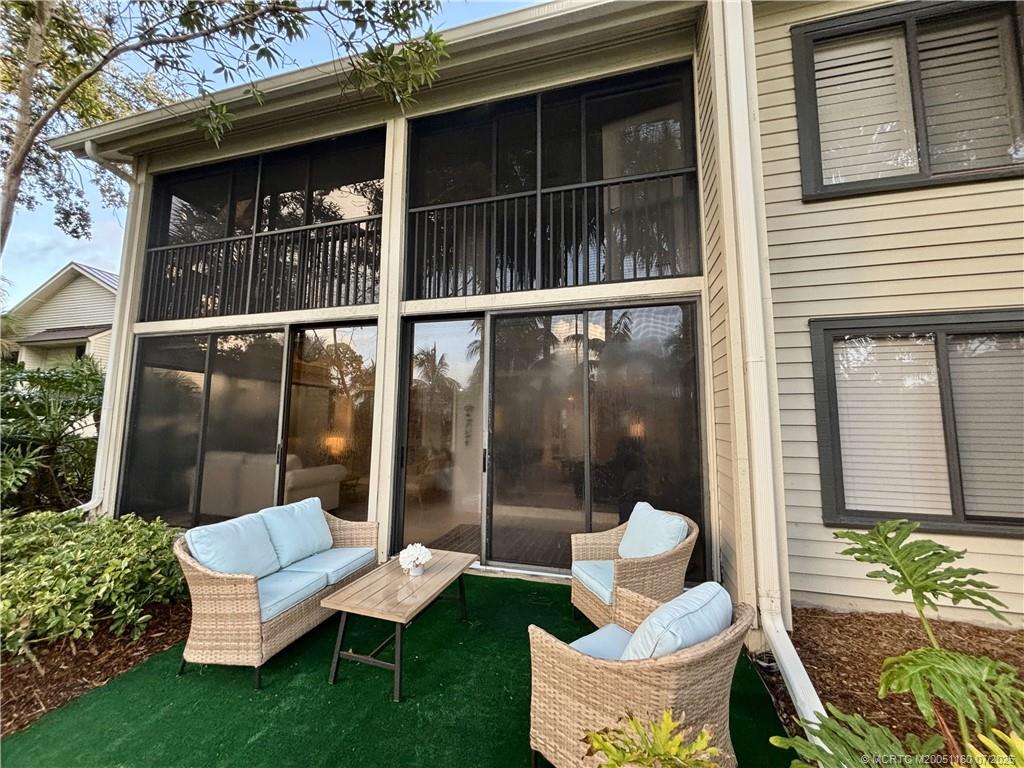 5152 Southeast Club Way, Unit 104 Stuart, FL 34997 - Photo 19 of 28 a view of a patio with couches chairs and a potted plant
