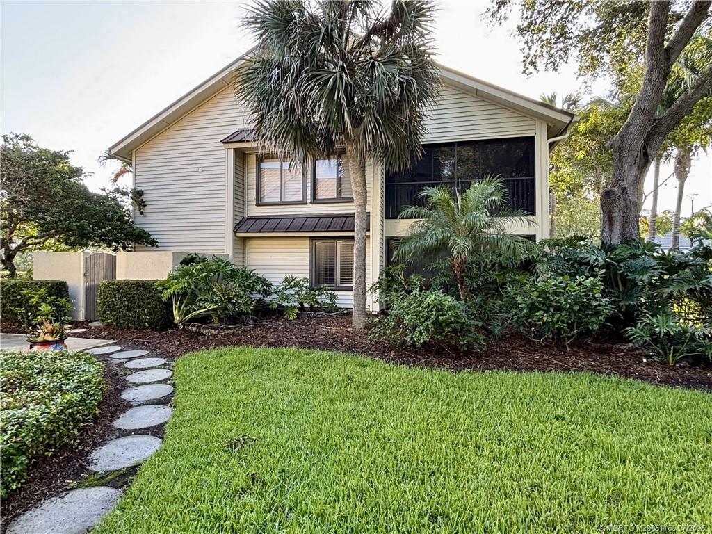 5152 Southeast Club Way, Unit 104 Stuart, FL 34997 - Photo 21 of 28 a front view of house with yard and green space