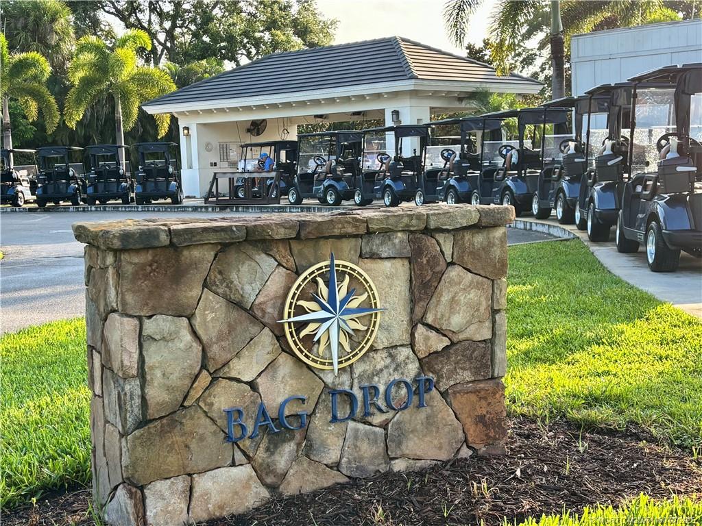 5152 Southeast Club Way, Unit 104 Stuart, FL 34997 - Photo 23 of 28 a view of a chairs and table in the patio