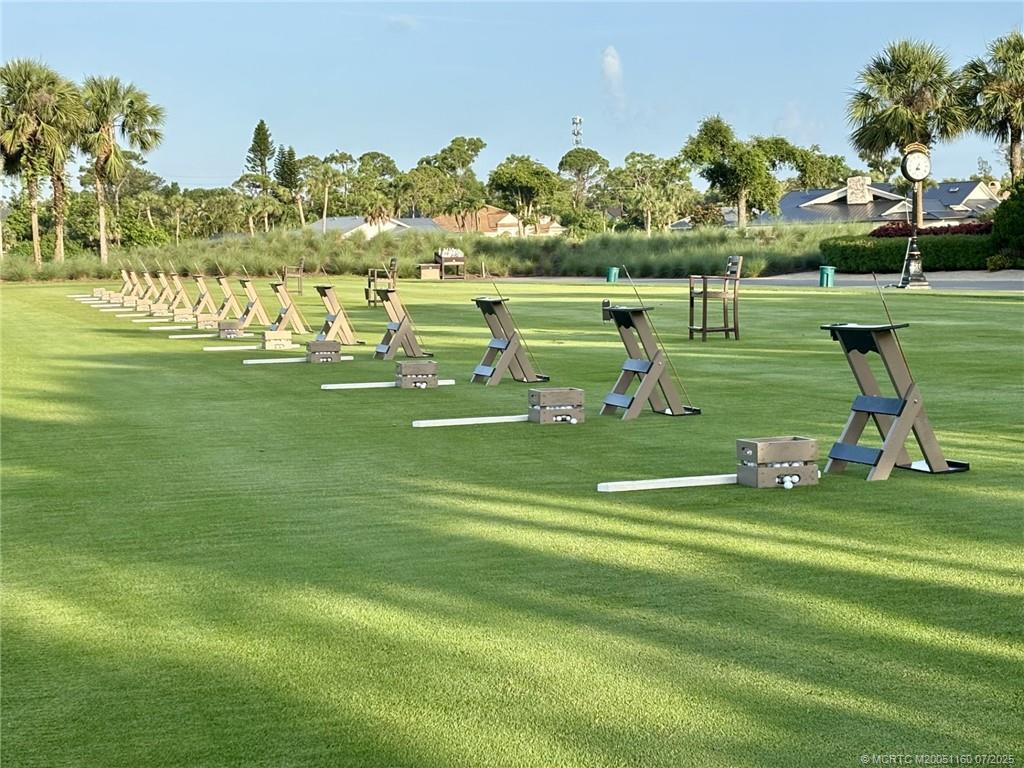 5152 Southeast Club Way, Unit 104 Stuart, FL 34997 - Photo 24 of 28 a view of a golf course with a lake