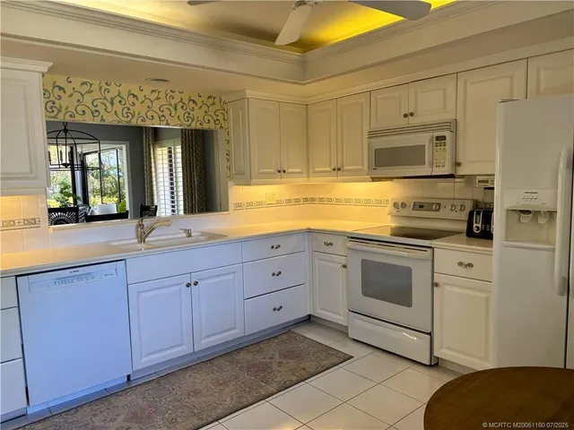 a kitchen with stainless steel appliances granite countertop a sink and cabinets