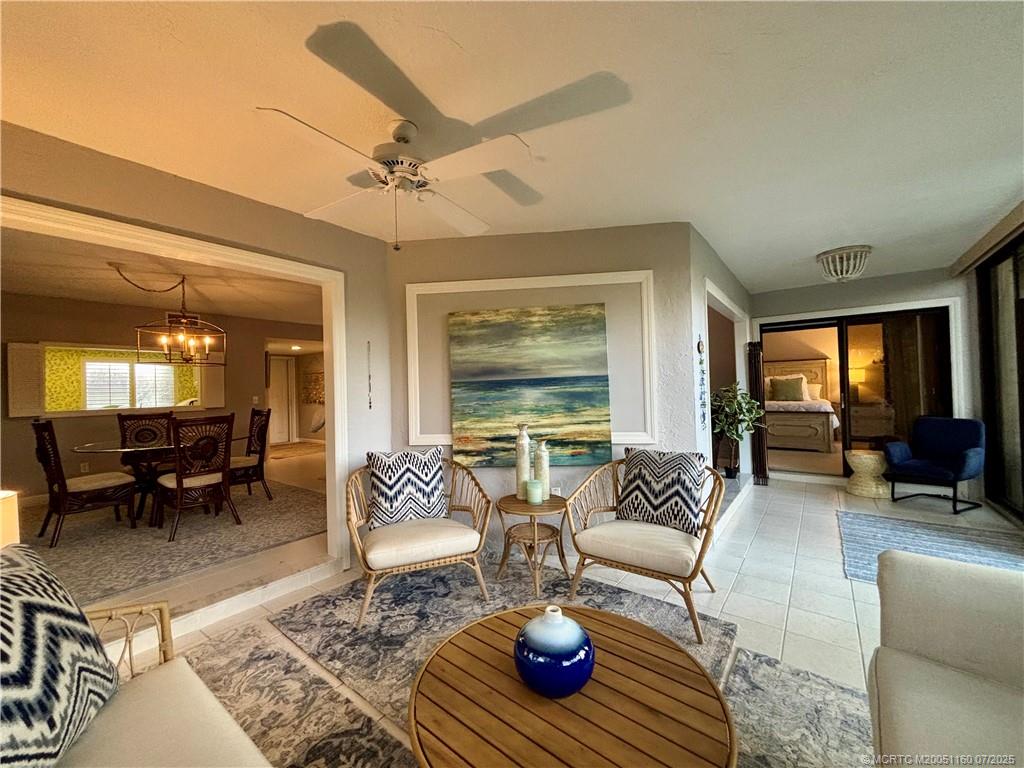 5152 Southeast Club Way, Unit 104 Stuart, FL 34997 - Photo 10 of 28 a living room with furniture or couch and a large window