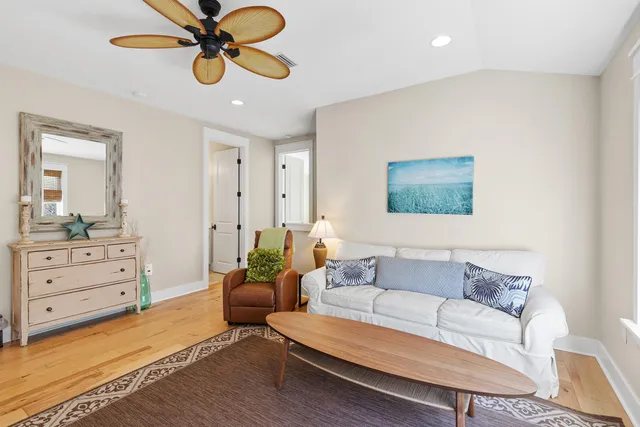 a living room with furniture and a ceiling fan
