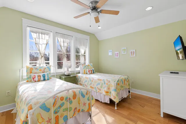 a bedroom with two beds and a chandelier