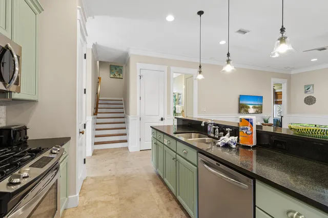 a kitchen with stainless steel appliances granite countertop a stove and a sink