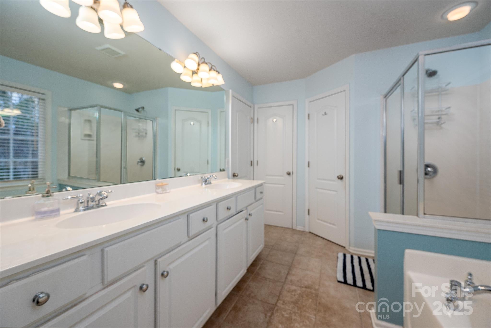 2223 Blueberry Ridge Road Matthews, NC 28105 - Photo 16 of 25 a spacious bathroom with double sink and a mirror