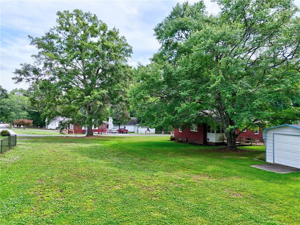 102 Graham Honea Path, SC 29654 - Photo 25 of 29 A spacious, verdant yard with mature trees offers a serene outdoor setting.