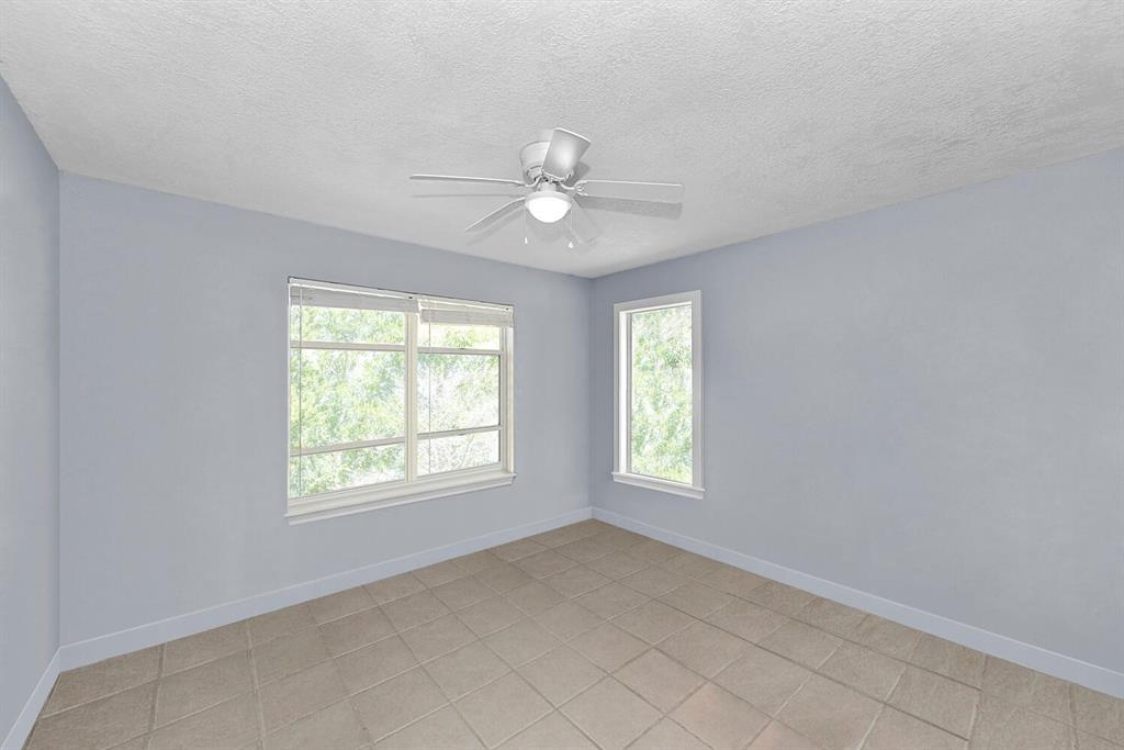 2962 Southeast Darien Road Port St. Lucie, FL 34952 - Photo 22 of 33 an empty room with chandelier fan and windows