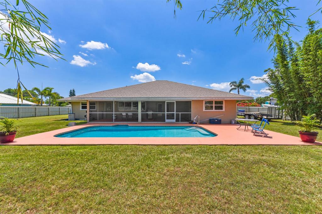 2962 Southeast Darien Road Port St. Lucie, FL 34952 - Photo 29 of 33 a view of pool with umbrella and trees