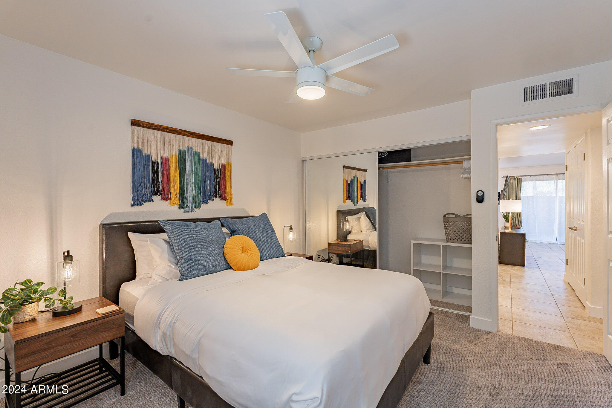 3500 North Hayden Road, Unit 1005 Scottsdale, AZ 85251 - Photo 17 of 51 a bedroom with a bed and a chandelier