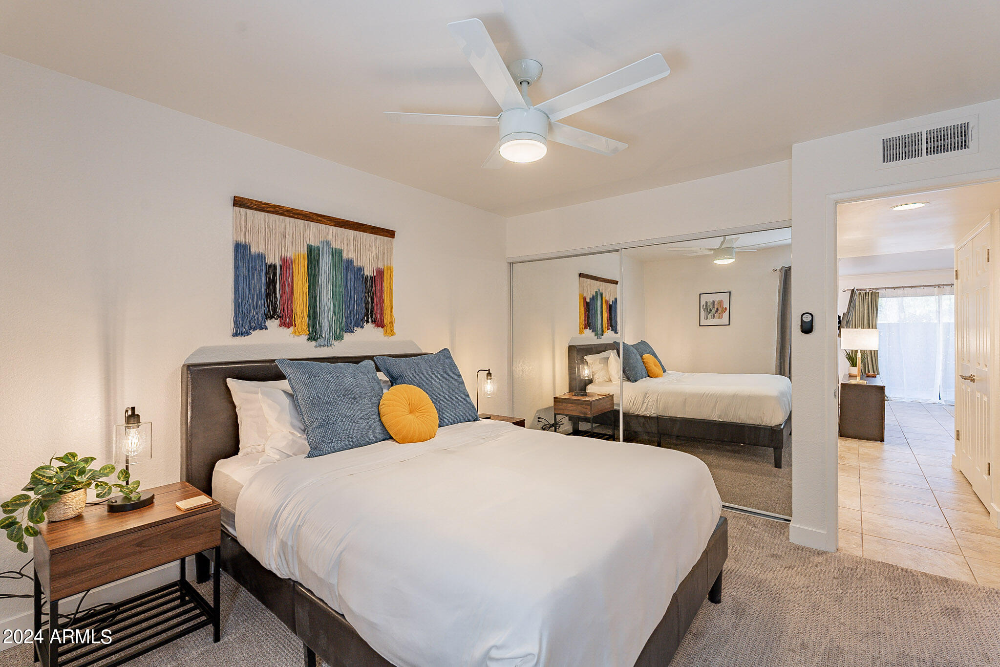 3500 North Hayden Road, Unit 1005 Scottsdale, AZ 85251 - Photo 18 of 51 a bedroom with a bed and a chandelier