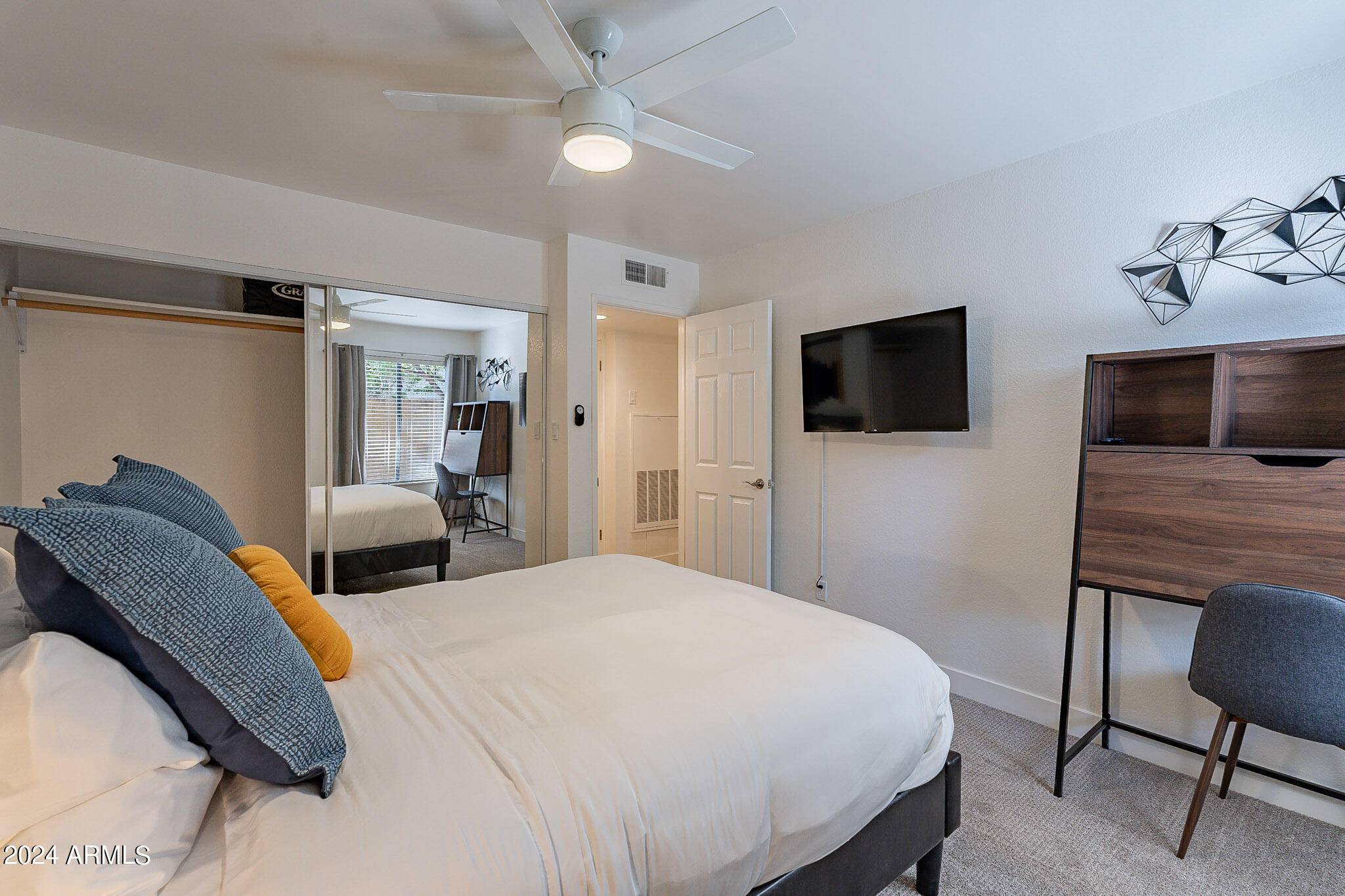 3500 North Hayden Road, Unit 1005 Scottsdale, AZ 85251 - Photo 19 of 51 a bedroom with a bed and a flat screen tv