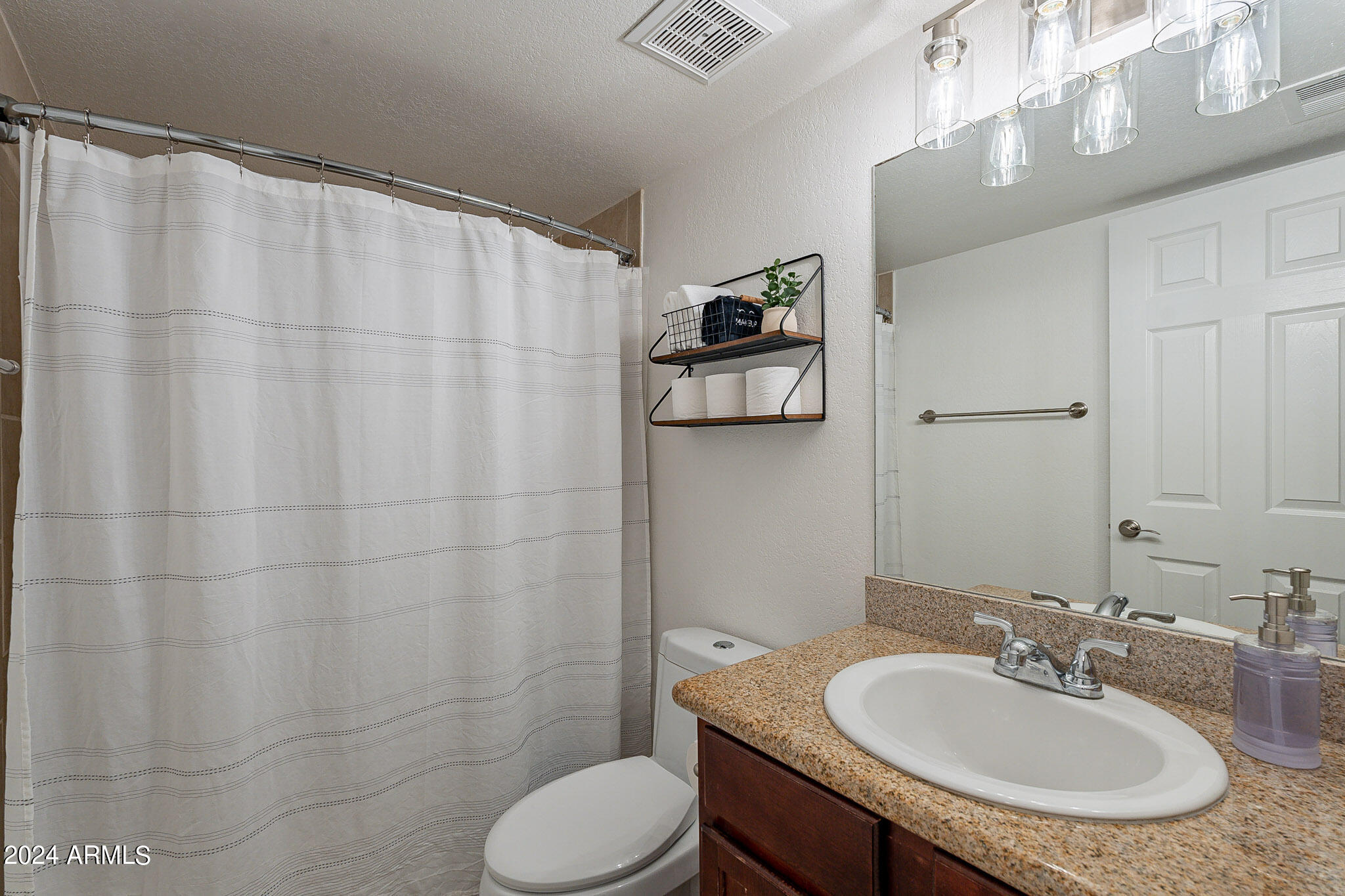3500 North Hayden Road, Unit 1005 Scottsdale, AZ 85251 - Photo 20 of 51 a bathroom with a granite countertop sink and a mirror