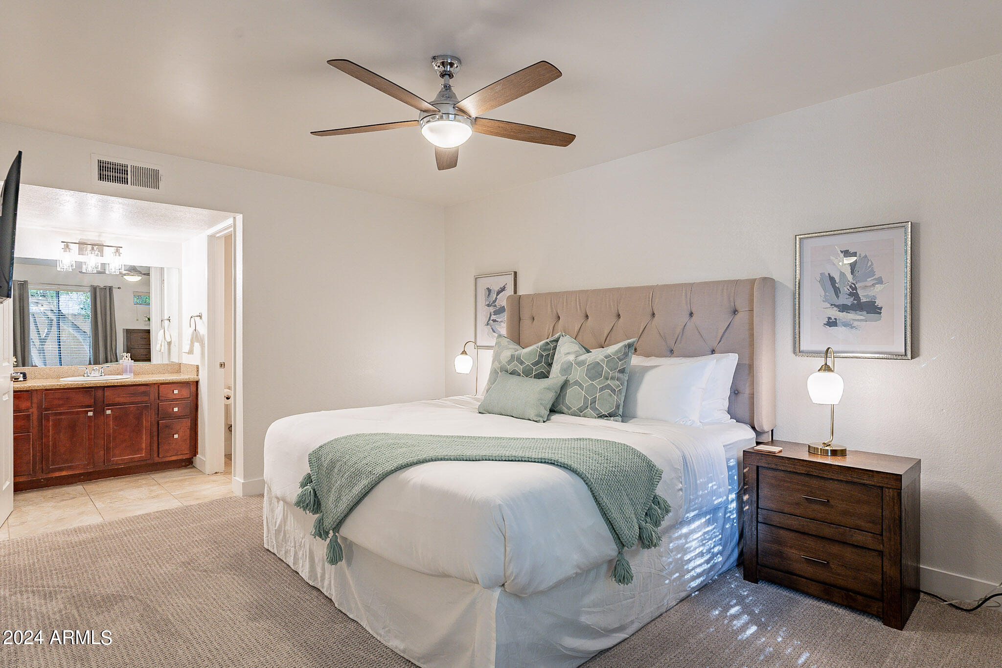 3500 North Hayden Road, Unit 1005 Scottsdale, AZ 85251 - Photo 23 of 51 a bedroom with a bed and a dresser