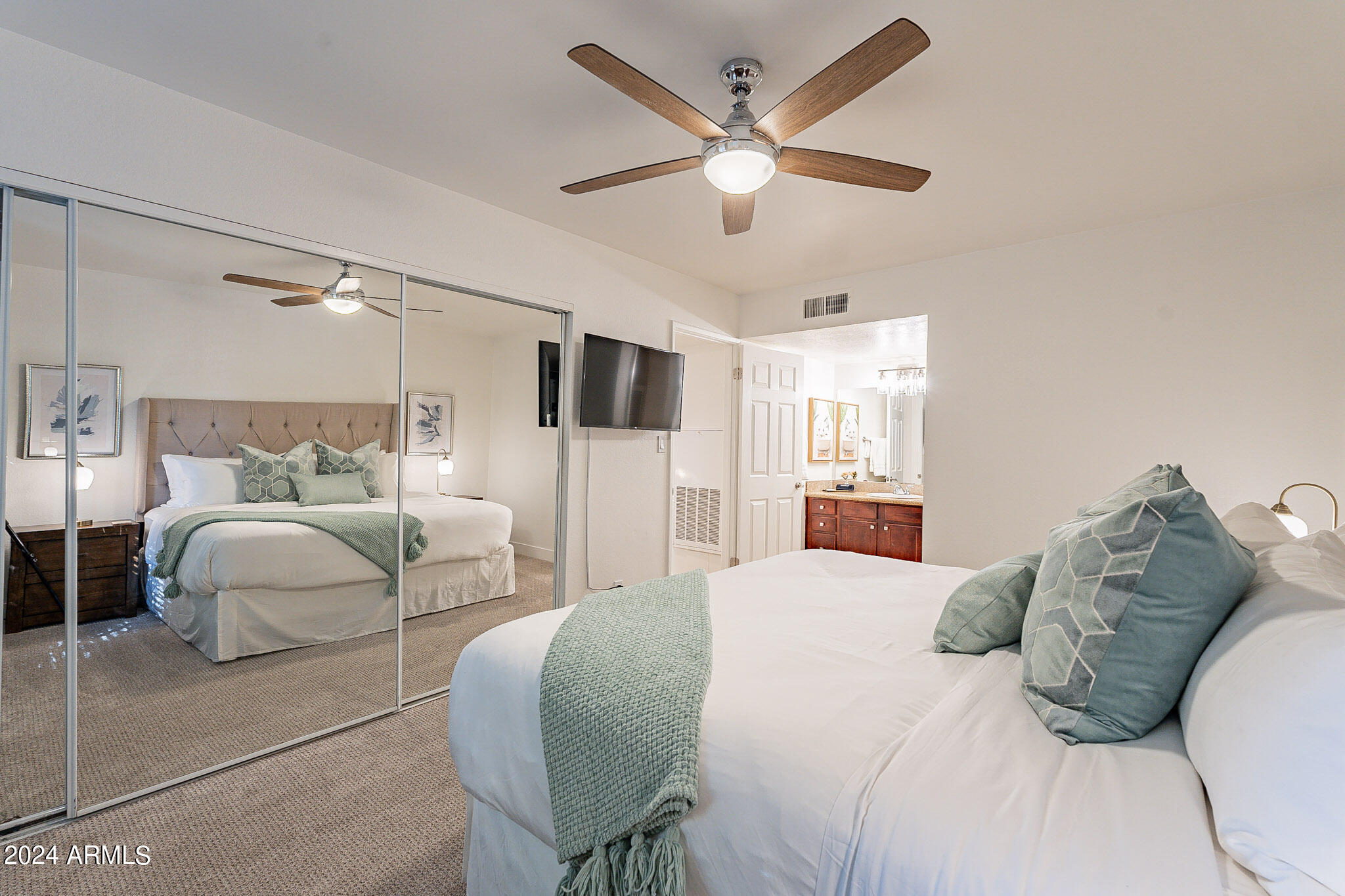 3500 North Hayden Road, Unit 1005 Scottsdale, AZ 85251 - Photo 24 of 51 a bedroom with a large bed and a chandelier