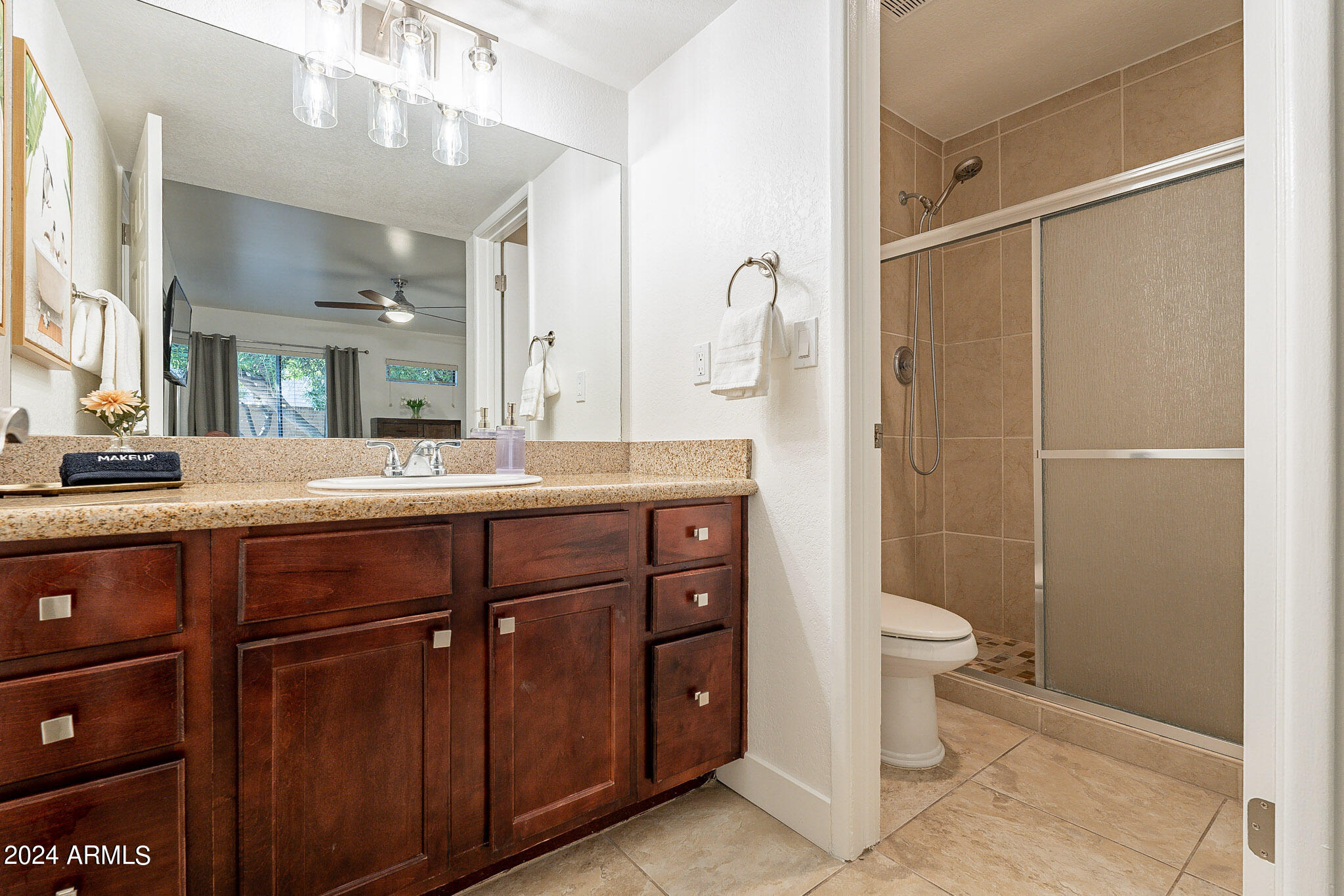 3500 North Hayden Road, Unit 1005 Scottsdale, AZ 85251 - Photo 27 of 51 a bathroom with a double vanity sink a toilet and a mirror