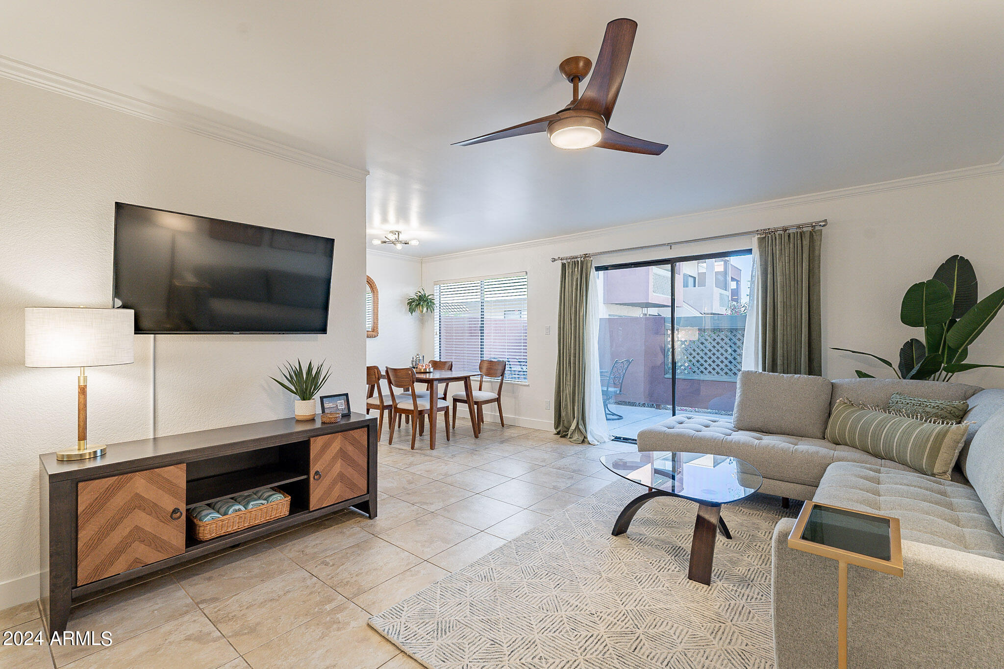 3500 North Hayden Road, Unit 1005 Scottsdale, AZ 85251 - Photo 3 of 51 a living room with furniture and a flat screen tv