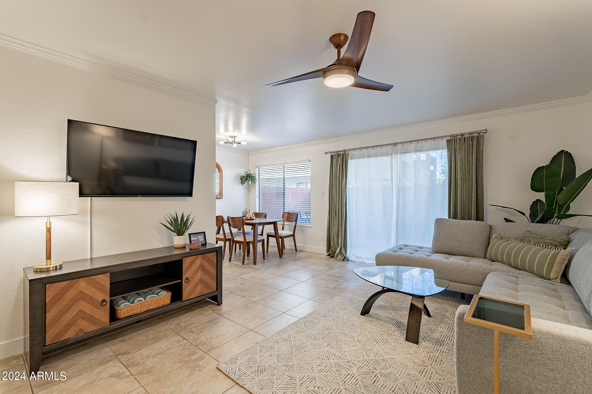 3500 North Hayden Road, Unit 1005 Scottsdale, AZ 85251 - Photo 4 of 51 a living room with furniture and a flat screen tv