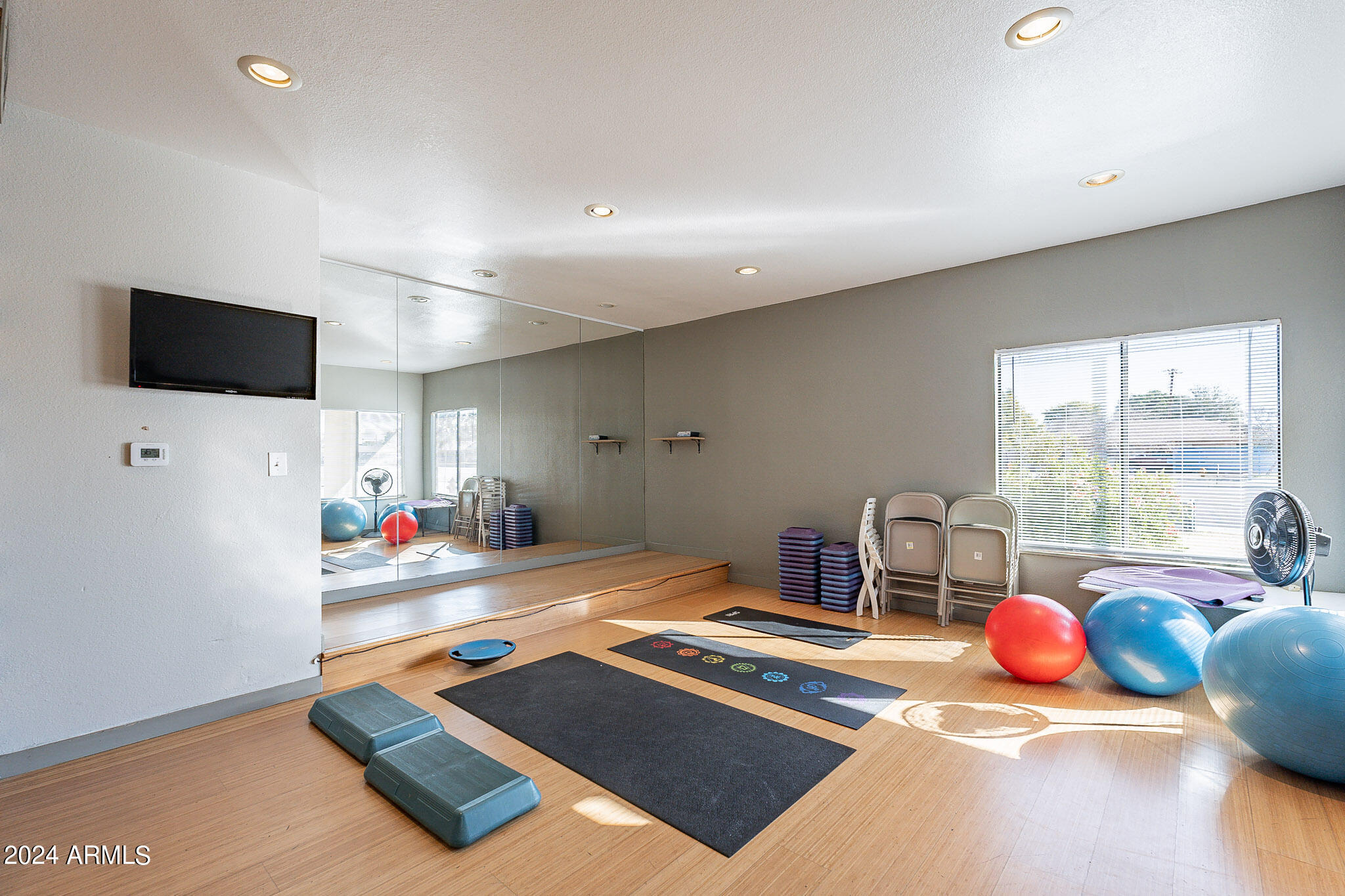 3500 North Hayden Road, Unit 1005 Scottsdale, AZ 85251 - Photo 45 of 51 a living room with furniture flat screen tv and a large window