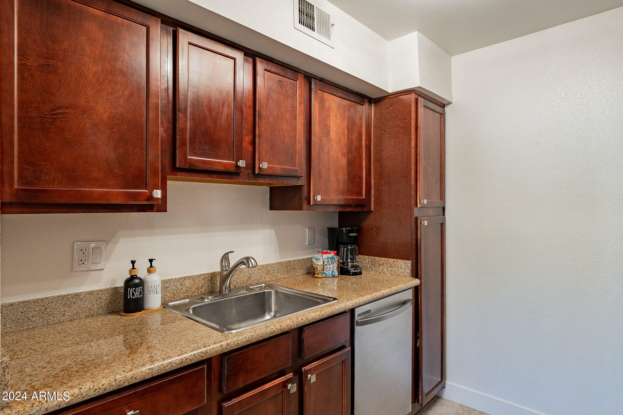 3500 North Hayden Road, Unit 1005 Scottsdale, AZ 85251 - Photo 7 of 51 a kitchen with stainless steel appliances granite countertop a sink a refrigerator and cabinets