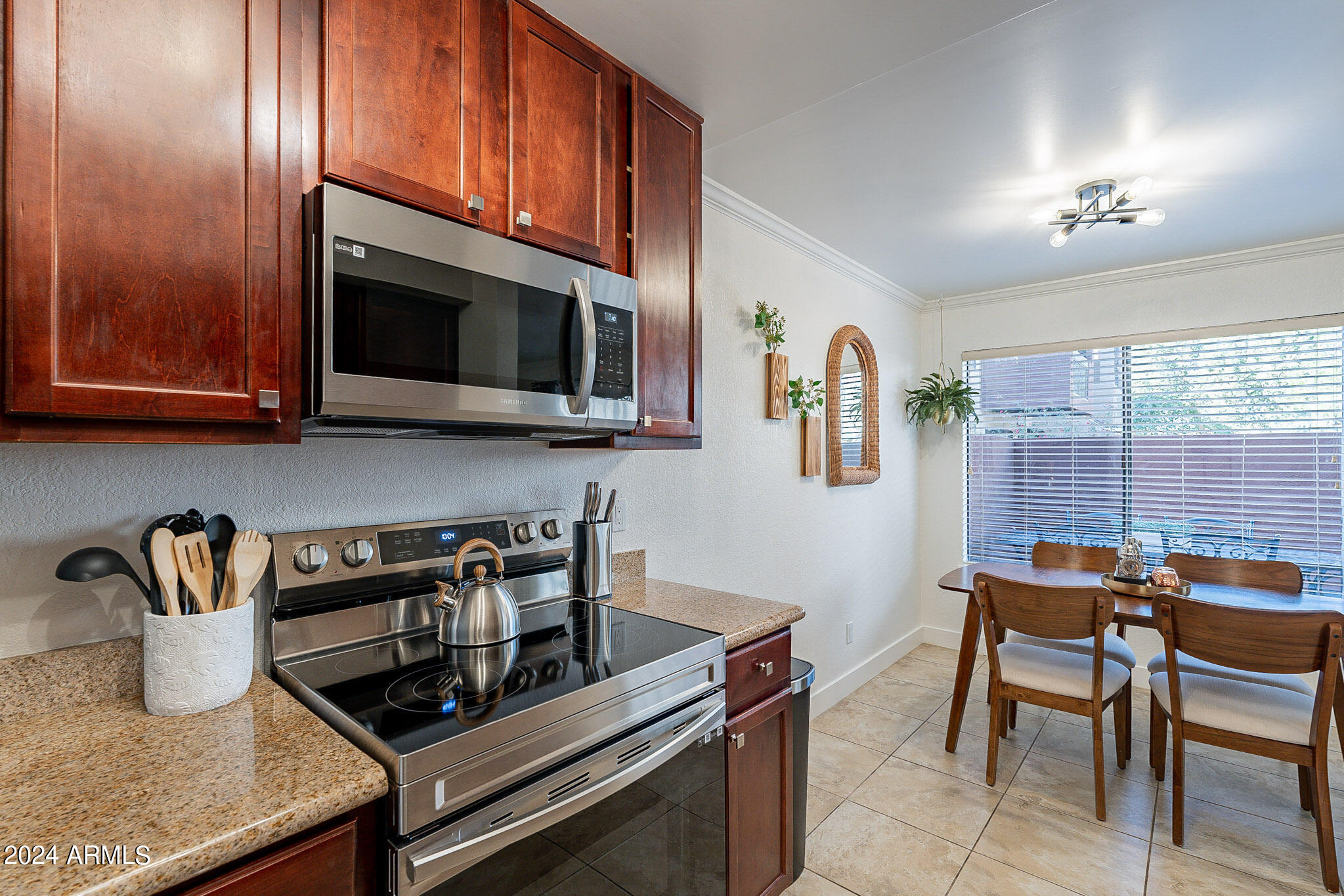 3500 North Hayden Road, Unit 1005 Scottsdale, AZ 85251 - Photo 10 of 51 a kitchen with stainless steel appliances granite countertop a stove and a microwave