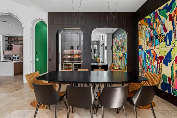 a living room with furniture a rug and a painting on the wall