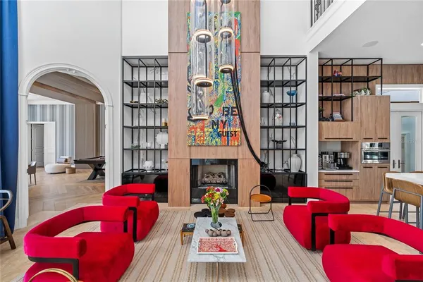 a living room with furniture pool table and a flat screen tv