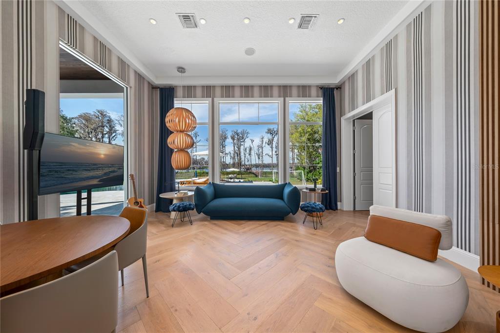 9343 Tibet Pointe Circle Windermere, FL 34786 - Photo 45 of 100 a living room with furniture a large window and a flat screen tv