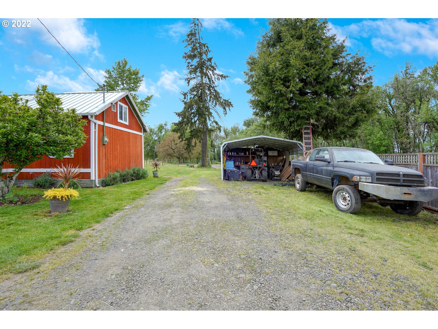 8840 Stapleton Road Independence, OR 97351 - Photo 3 of 26 a view of a house with a garden and parking space